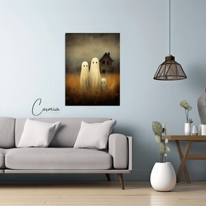May include: A canvas print featuring a spooky Halloween scene. Three white ghost figures stand in a field of tall grass, with a haunted house in the background. The artwork has a vintage, slightly blurred aesthetic. The word "Cosmia" is in the lower left corner.