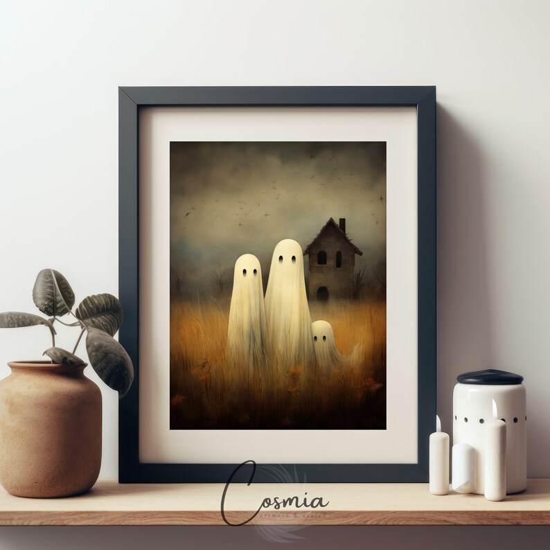 May include: A framed print featuring a spooky scene with three white ghosts in a field of tall grass, with a haunted house in the background. The artwork has a vintage, slightly blurred aesthetic, perfect for Halloween decor.
