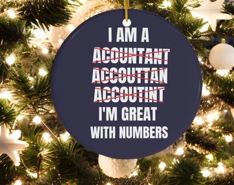 May include: A blue Christmas ornament with the text "I am a Accountant I'm great with numbers" with the word "Accountant" crossed out multiple times.