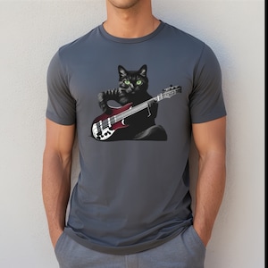 May include: A dark gray t-shirt with a black cat playing a red electric bass guitar. The cat has green eyes.