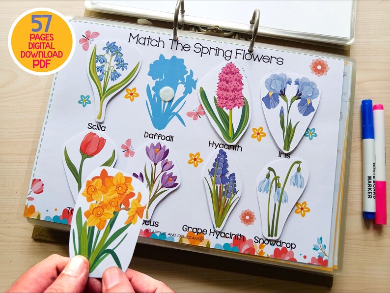 May include: A colorful educational activity featuring spring flowers. The image shows a binder with flower cutouts labeled with names like Scilla, Daffodil, and Hyacinth. The text "Match The Spring Flowers" is visible. The image also includes two markers and the text "57 PAGES DIGITAL DOWNLOAD PDF".
