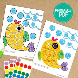 May include: Two printable worksheets featuring a yellow fish with a green fin and purple tail. The fish is made up of circles that can be filled in with stickers or markers. The text on the worksheets reads "sticker (use Min. 25mm) or marker to dot the circles" and "use dot sticker (use Min. 25mm) or bingo dot marker to dot the circles".