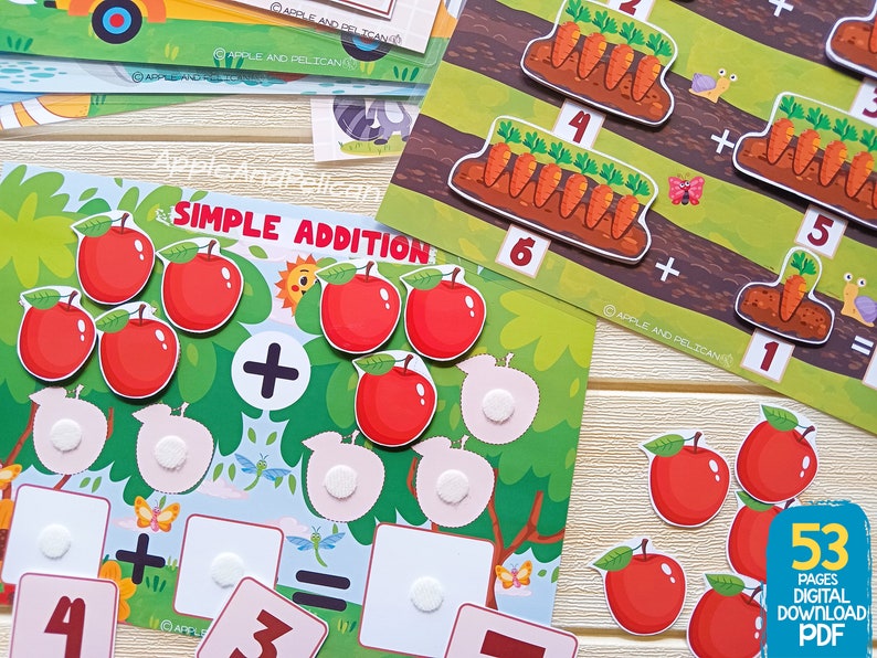 May include: A colorful educational game for kids featuring a simple addition problem with apples. The game includes a green tree with red apples, a plus sign, and blank spaces for the answer. The text "Simple Addition" is printed on the game board.
