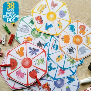 May include: A set of 38 printable pages featuring colorful, illustrated cards with various images, including a squirrel, a ladybug, a watermelon, a frog, a bat, a spider, a pumpkin, a watering can, a helicopter, a bus, a rooster, a grape, a cactus, a turtle, a shoe, a chick, a lion, a watering can, and a tractor. The cards are designed for a game or activity.