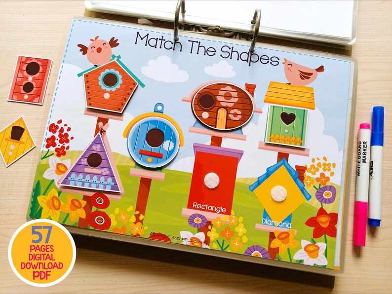May include: A colorful educational activity book with the title "Match The Shapes". The book features various birdhouse shapes, including a triangle, rectangle, and diamond. Includes a pink and blue marker.