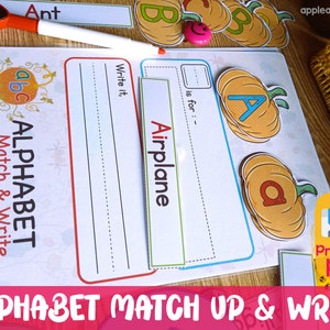 May include: A printable alphabet matching and writing activity for kids. The worksheet features a pumpkin with the letter "A" and the word "Airplane" written on a separate card. The worksheet is designed to help children learn the alphabet and improve their writing skills.