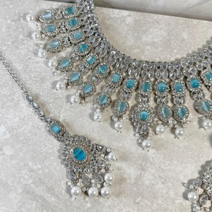 May include: A rustic wooden sign with the text "Welcome to our home" in white lettering. The sign features a distressed finish and a simple, inviting design, perfect for front door decor.