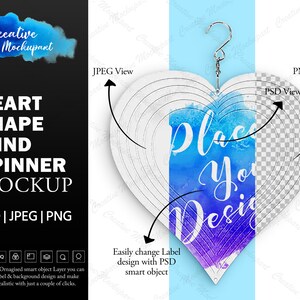 May include: A heart-shaped wind spinner mockup with a watercolor design. The design features a blue and purple watercolor background with the text "Place Your Design" in white. The wind spinner is hanging from a silver hook.