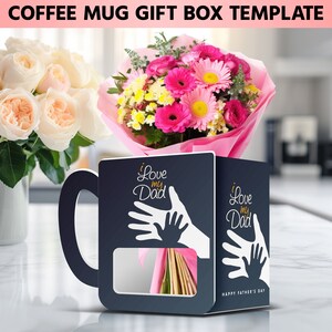 Puede incluir: Una plantilla de caja de regalo de taza de caf&eacute; negra con un recorte para un ramo de flores. La caja presenta un dise&ntilde;o de huella de mano blanca con el texto "Te amo pap&aacute;" y "Feliz d&iacute;a del padre".