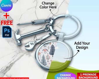 May include: A silver key ring with miniature tools: a hammer, wrench, and screwdriver. The key ring also features a round charm with a nature-themed design. The text "HAMMER ORNAMENT KEY RING CANVA MOCKUP" is at the top.