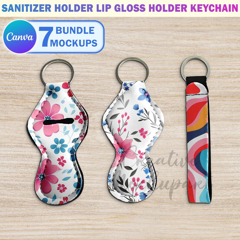 May include: Three keychains with different designs. The first two are floral patterned, one with pink and blue flowers and the other with pink and gray flowers. The third keychain has a colorful abstract design with red, orange, yellow, blue, and white.