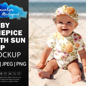 May include: A baby wearing a floral print onesie and a floral print sun hat sits on a sandy beach.
