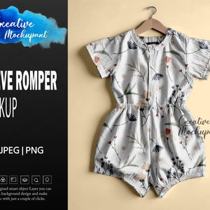 May include: A short-sleeved romper with a floral pattern, hanging on a wooden hanger. The romper is white with a vertical striped texture and features a delicate print of flowers in shades of blue, red, and beige. The words "SLEEVE ROMPER MOCKUP" are visible.