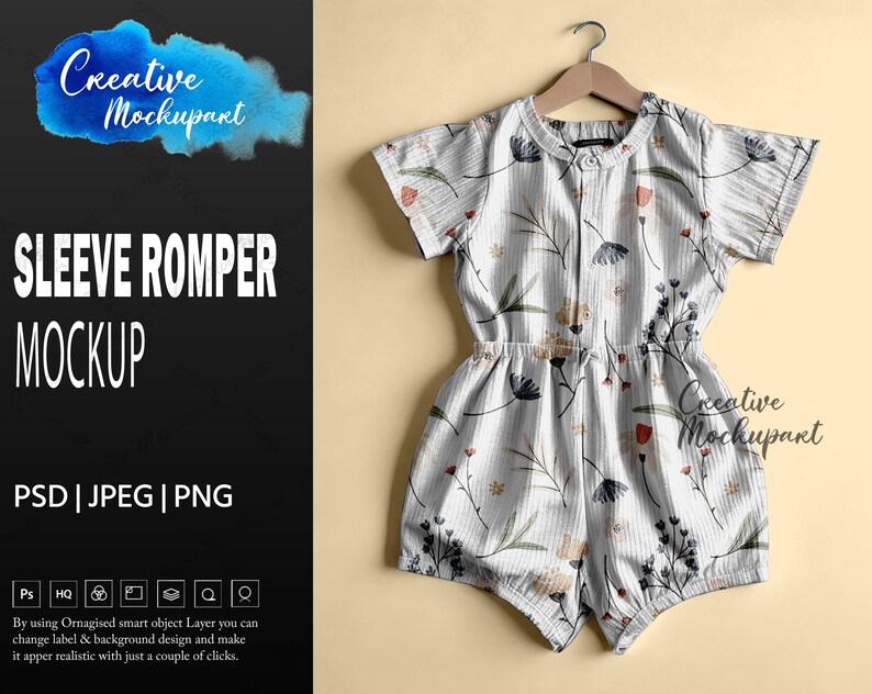 May include: A short-sleeved romper with a floral pattern, hanging on a wooden hanger. The romper is white with a vertical striped texture and features a delicate print of flowers in shades of blue, red, and beige. The words "SLEEVE ROMPER MOCKUP" are visible.