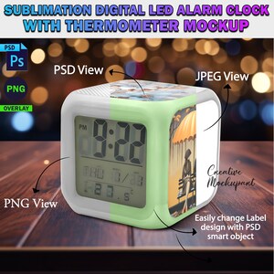 May include: A white and green digital alarm clock with a thermometer and a customizable design. The clock face displays "9:22 PM" and the design features a colorful illustration of a woman sitting under an umbrella.