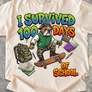 May include: Cream-colored t-shirt with a graphic featuring a bulldog on a skateboard, wearing a green jacket and cap. Text reads "I Survived 100 Days of School" in colorful graffiti-style lettering. Includes a backpack and books.