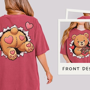 May include: Maroon t-shirt featuring a cartoon bear design. The front design shows a bear holding a box of chocolates, surrounded by hearts. The back design shows the bear's rear with heart-shaped patches. The words "FRONT DESIGN" are in the image.