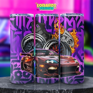 May include: A purple and red tumbler featuring a sports car, wheels, and flames design. The tumbler has a graffiti-style background and the text "Lonardy Designs".
