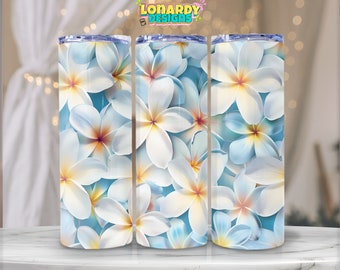 May include: Three stainless steel tumblers with a white floral design. The flowers are white with yellow centers and are arranged on a light blue background.