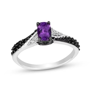 May include: A silver ring with a purple amethyst gemstone and black and white diamonds. The ring has a delicate design with a twisted band.