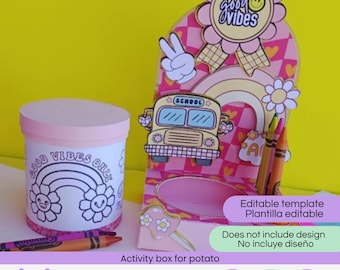 May include: A cylindrical container with a pink lid and a white body featuring a black outline of a rainbow and the text Good Vibes Only, next to a cardboard display stand with a school bus graphic, a peace sign, and a flower badge.