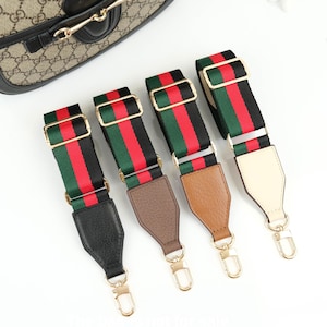 May include: Four adjustable purse straps with gold-tone hardware. Each strap features a red, green, and black striped pattern. The leather ends are black, brown, tan, and cream. The bag in the background is not for sale.