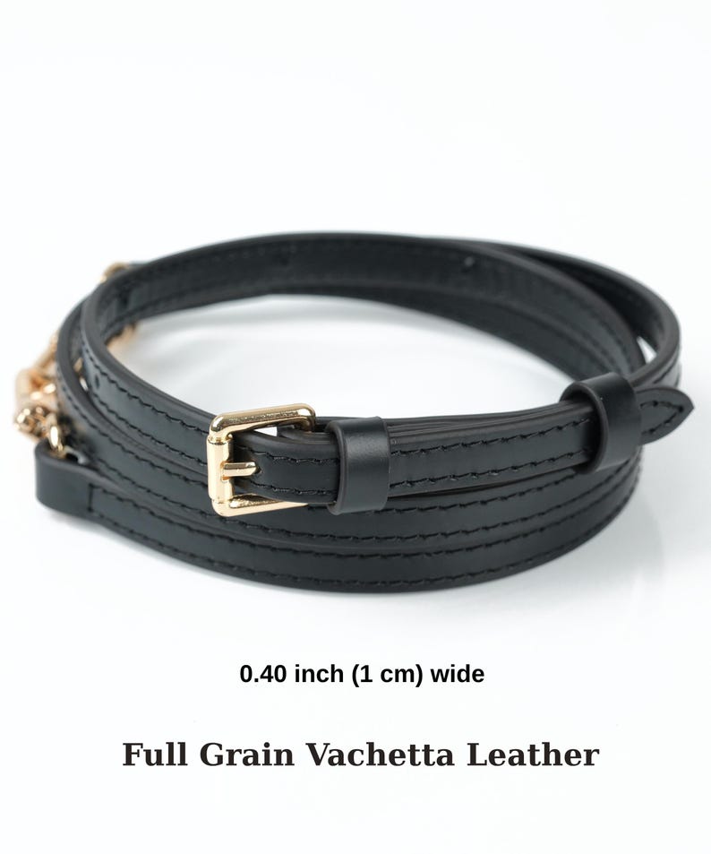 May include: A black leather belt, 1 cm wide, with a gold-coloured buckle. The belt is made of full-grain vachetta leather and is wrapped in a spiral. The text on the image reads: 0.40 inch (1 cm) wide, Full Grain Vachetta Leather.