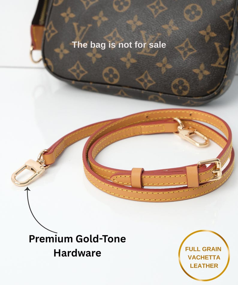 May include: A brown handbag with a repeating pattern and a separate tan leather strap with gold-tone hardware. The strap is made of full-grain vachetta leather. The bag is not for sale.