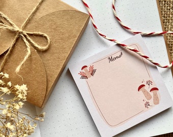 May include: A brown paper package tied with twine, a red and white string, and a pink notepad with a mushroom illustration and the word "Memories".