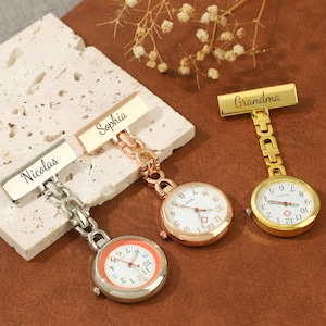 May include: Three gold-toned pocket watches with personalized name tags. The watches have a chain and a clip to attach to clothing. The names on the tags are Nicolas, Sophia, and Grandma.