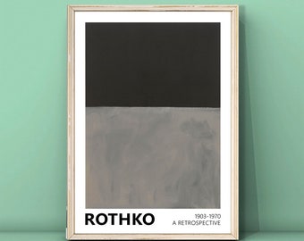 May include: A framed print of a minimalist abstract painting by Mark Rothko. The painting features two horizontal bands of color, a dark gray top band and a lighter gray bottom band. The print includes the artist's name, "Rothko", and the dates "1903-1970" and "A Retrospective".