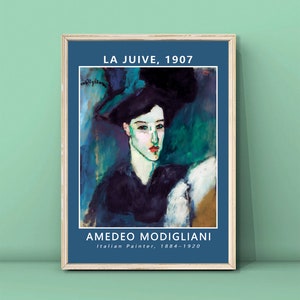 May include: A framed print of a painting by Amedeo Modigliani titled "La Juive, 1907". The painting depicts a woman with dark hair wearing a black hat and a black dress. The background is a vibrant blue and green.