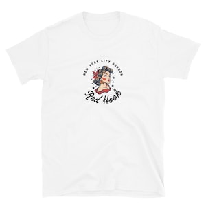 May include: White t-shirt with a vintage-style illustration of a woman with a red flower in her hair. The illustration is surrounded by a circle with the text "New York City Harbor Red Hook".