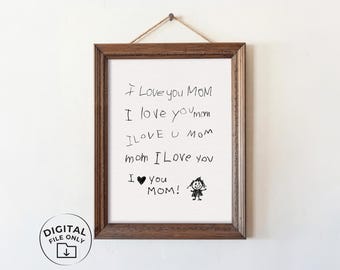 May include: A rectangular wooden frame containing a white print with black handwritten text that reads I Love you MOM, I love you mom, I LOVE U mom, mom I Love you, and I heart you MOM! with a small stick figure drawing of a person.