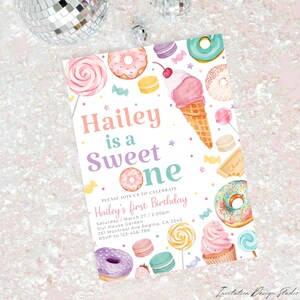 May include: A colorful invitation for a first birthday party with a sweet theme. The invitation features a donut, ice cream cone, and other sweet treats. The text on the invitation reads "Hailey is a Sweet One".