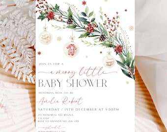 May include: A white baby shower invitation with a watercolor illustration of a Christmas wreath with ornaments. The text reads "Join us for a merry little baby shower honoring mom-to-be Amelia Robert, Saturday 15th December at 5:00pm, 251 Montreal Ave Regina, CA 2442, RSVP to Amanda 123-456-789, www.babylist.com".