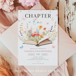 May include: A white invitation card featuring a floral design and an open book. The text on the card reads "Chapter One" and "Amelia's First Birthday". The invitation includes the date, time, and location of the party.