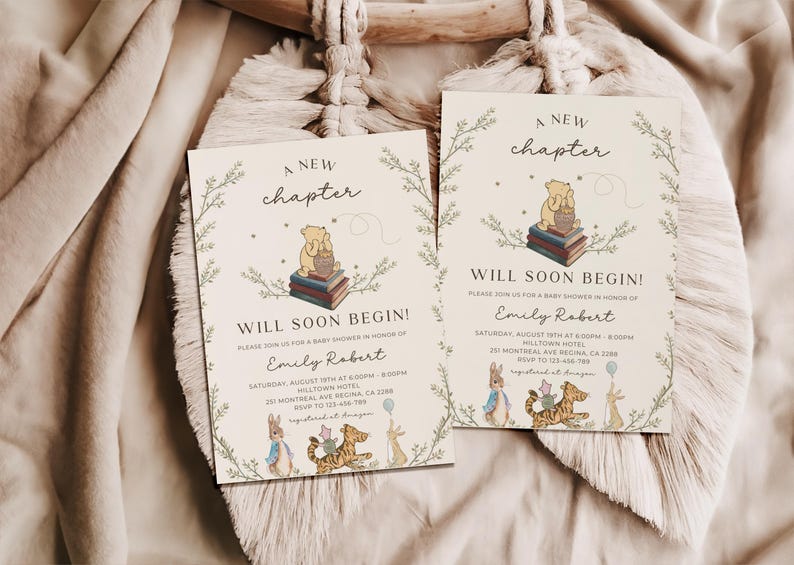 May include: Two Winnie the Pooh themed baby shower invitations with a green leafy border. The invitations feature the text "A new chapter will soon begin!" and a cartoon image of Winnie the Pooh sitting on a stack of books. The invitations also include the text "Please join us for a baby shower in honor of Emily Robert".
