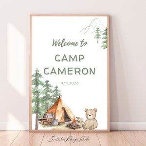 May include: Welcome to Camp Cameron, a watercolor illustration featuring a brown bear, a tent, a campfire, and green trees. The date 11.10.2023 is printed below the text.