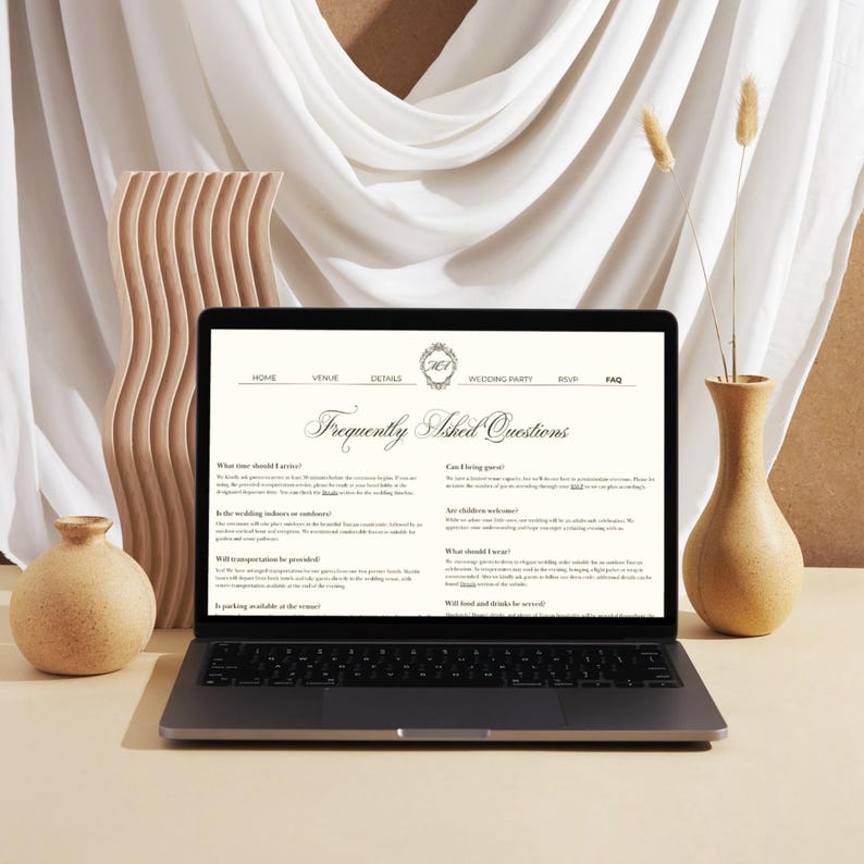 May include: A laptop displaying a wedding website with a Frequently Asked Questions page. The screen shows navigation links for Home, Venue, Details, Wedding Party, RSVP, and FAQ. The text is black on a cream background with a decorative logo at the top.