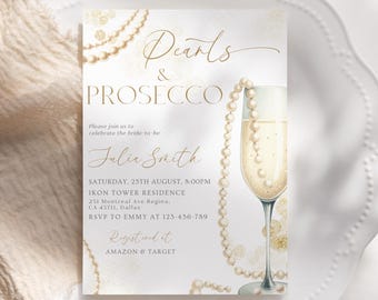 May include: A white invitation with gold lettering for a bridal shower. The invitation reads "Pearls & Prosecco" and includes the bride-to-be's name, Julia Smith. The invitation also includes the date, time, and location of the event, as well as the RSVP information. The invitation is decorated with a watercolor illustration of a champagne flute and a pearl necklace.