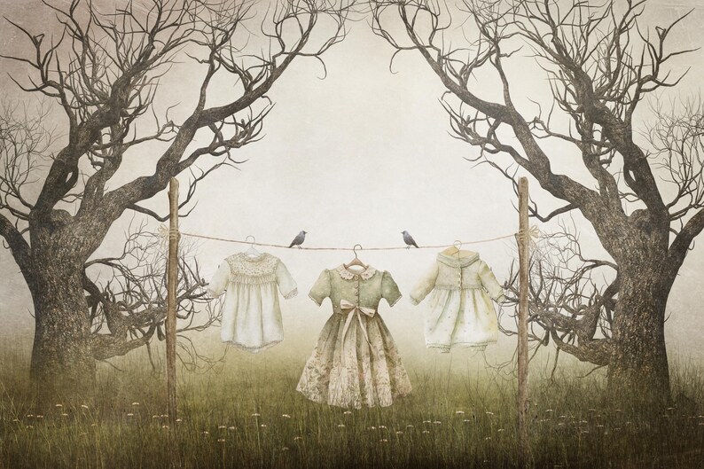 May include: Three white dresses hang on a clothesline between two bare trees. The dresses are different styles and have a vintage feel. The trees are silhouetted against a light gray background.