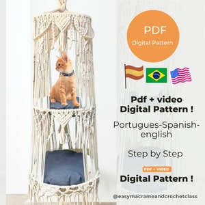 Puede incluir: Una hamaca para gatos de macramé blanco con dos plataformas. La hamaca está colgada del techo. Un gato está sentado en la plataforma superior. La imagen incluye el texto "PDF Digital Pattern", "Pdf + video Digital Pattern!", "Portugues-Spanish-english", "Step by Step", "PDF + VIDEO Digital Pattern!" y "@easymacrameandcrochetclass".