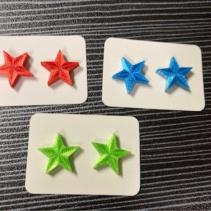 Star shaped earrings ,perfect for 4th of July celebrations! Titanium hypoallergenic stud post, star-burst design, red, white