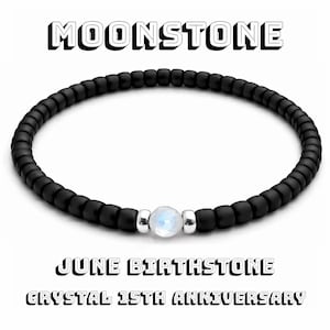 Op de afbeelding: Zwart kralenarmband met een centrale maansteen. Boven staat "MOONSTONE", onderaan "JUNE BIRTHSTONE" en "CRYSTAL 15TH ANNIVERSARY". Een stijlvol accessoire.