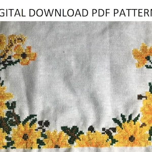 May include: A cross-stitch pattern featuring a border of yellow flowers with green leaves on a white background. The pattern is titled "DIGITAL DOWNLOAD PDF PATTERN".