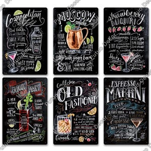 May include: Six black metal signs with white handwritten text and illustrations detailing cocktail recipes. Cocktails include Cosmopolitan, Moscow Mule, Strawberry Daiquiri, Bloody Mary, Old Fashioned, and Espresso Martini. Decorative bar signs.
