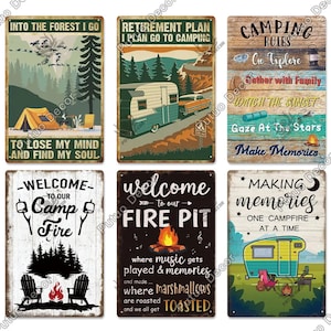 May include: A collection of six vintage-style metal signs with camping themes. The signs feature text like "Into the Forest I Go," "Retirement Plan," and "Making Memories." Each sign has a rustic, weathered look with various camping-related graphics.