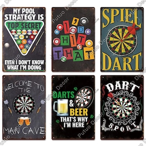 May include: Collection of six vintage-style metal signs with themes of billiards, darts, and beer. The signs feature text like "My Pool Strategy Is Top Secret" and "Darts & Beer That's Why I'm Here". Each sign has a distressed finish.