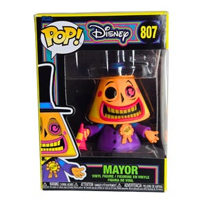May include: A Funko Pop! Disney figure of the Mayor from The Nightmare Before Christmas. The figure is in a box with the Funko Pop! and Disney logos. The Mayor is orange with a purple suit and a black top hat. The box reads "Mayor".